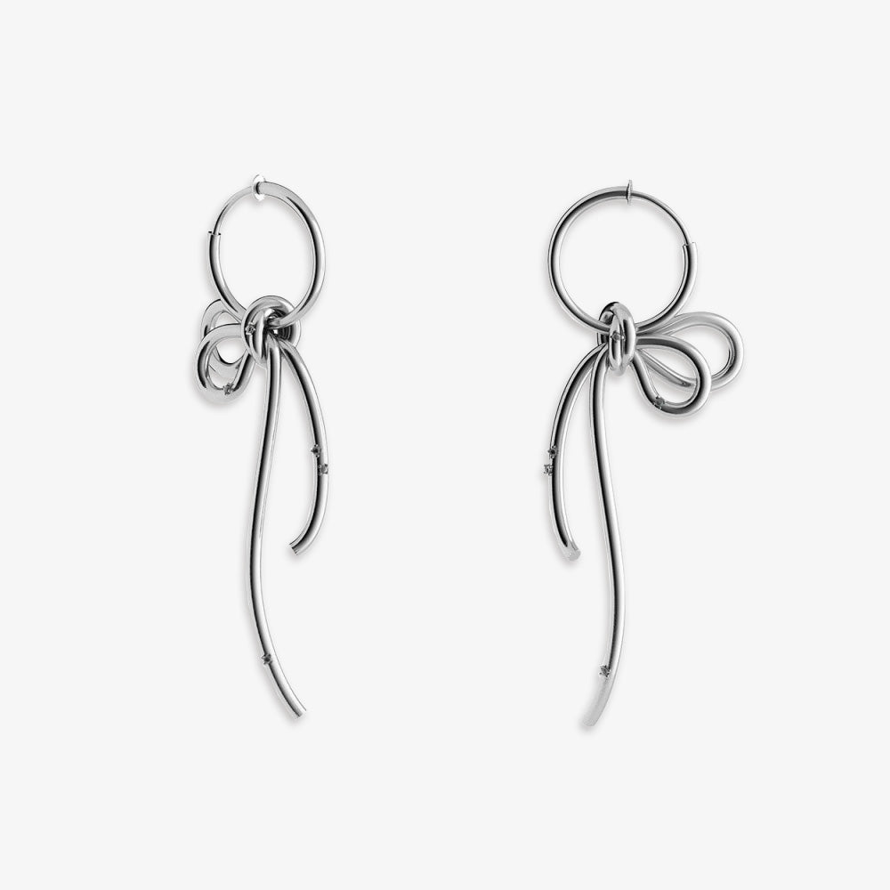 legant silver ribbon clip-on drop earrings, combining classic and contemporary styles, crafted from a sleek alloy. Designed for non-pierced ears, these earrings are equipped with a comfortable slide-spring clip-on closure. They're perfect for weddings, formal events, or as a unique gift option, featuring a flowing cascading ribbon design.
