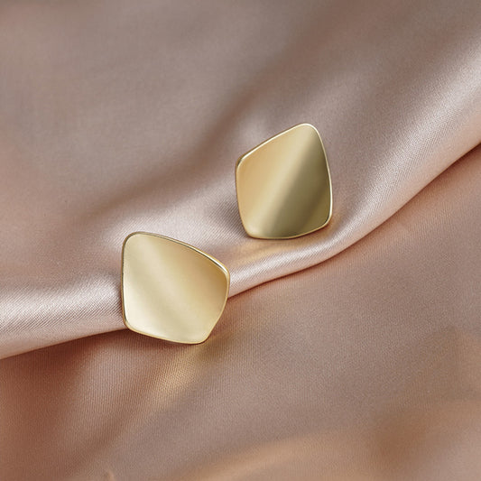 Go geometric with these gold square clip-on earrings. Eye-catching and modern, these earrings feature a chunky design that adds a touch of personality to any outfit.  Made from alloy with a comfortable coil clip closure, they're perfect for all-day wear, even for non-pierced ears.
