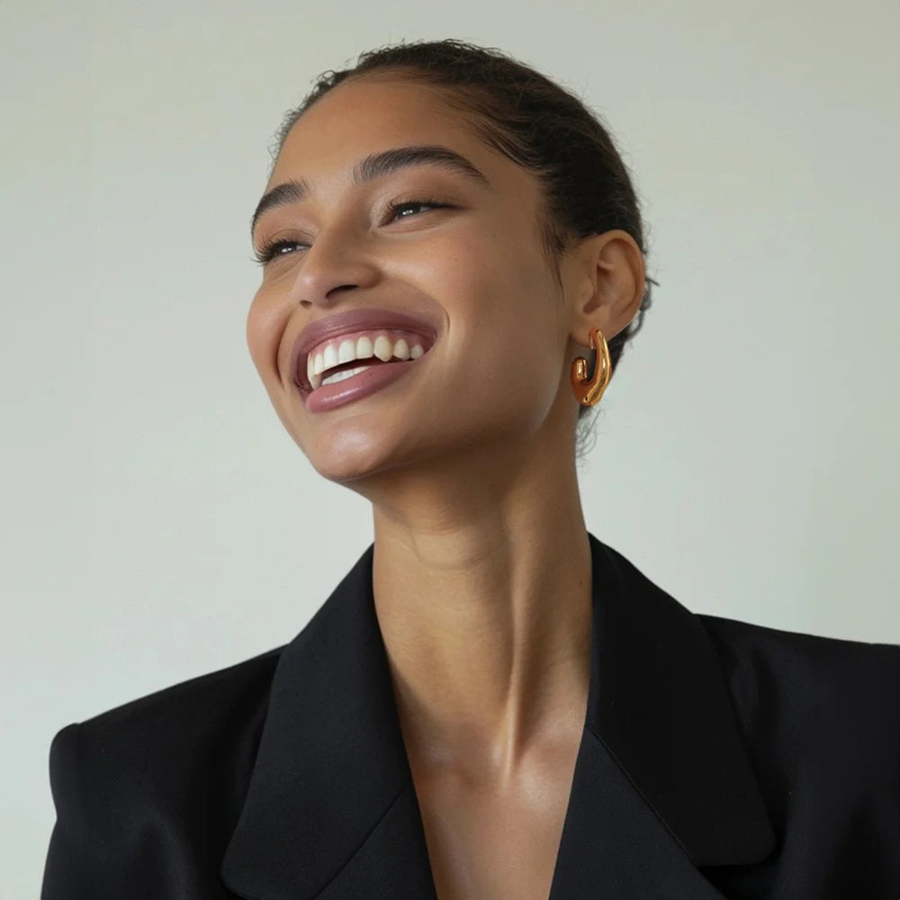 Model wearing Chunky Curved Gold Clip-On Earring