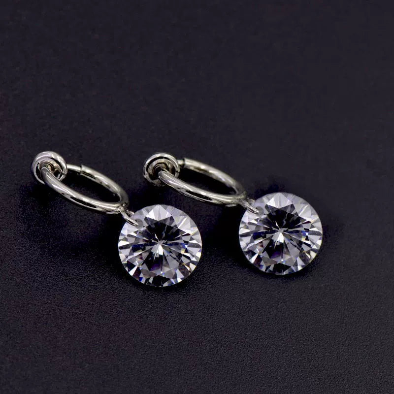 Diamond drop clip-on earrings displayed on a jewelry stand