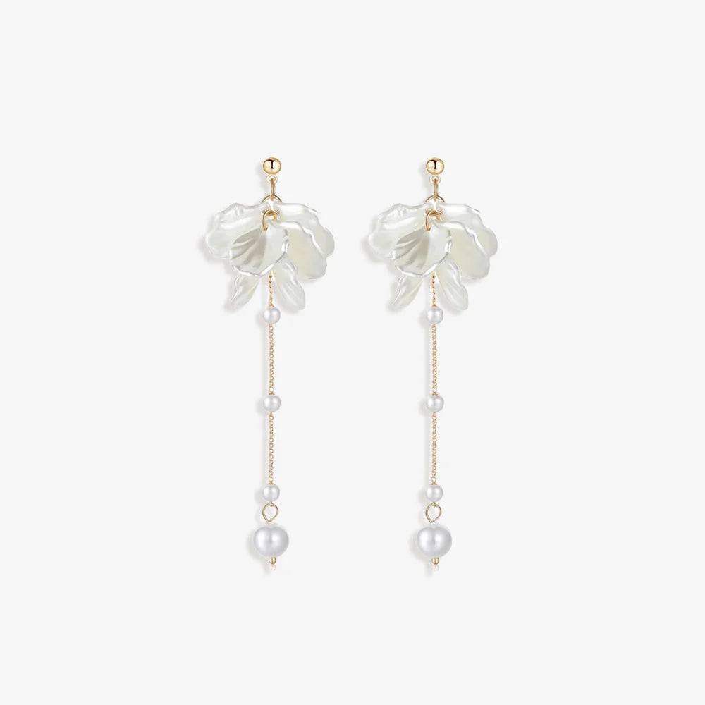 Pair of Floral Pearl Screw Back Earrings displayed on a soft white surface, capturing the intricate design and luxurious materials.
