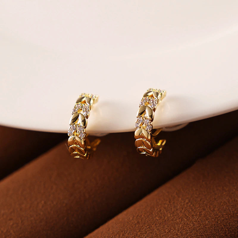 Gold Chain Zircon Clip-On Hoop Earrings displayed on a soft background, emphasizing their luxurious design.