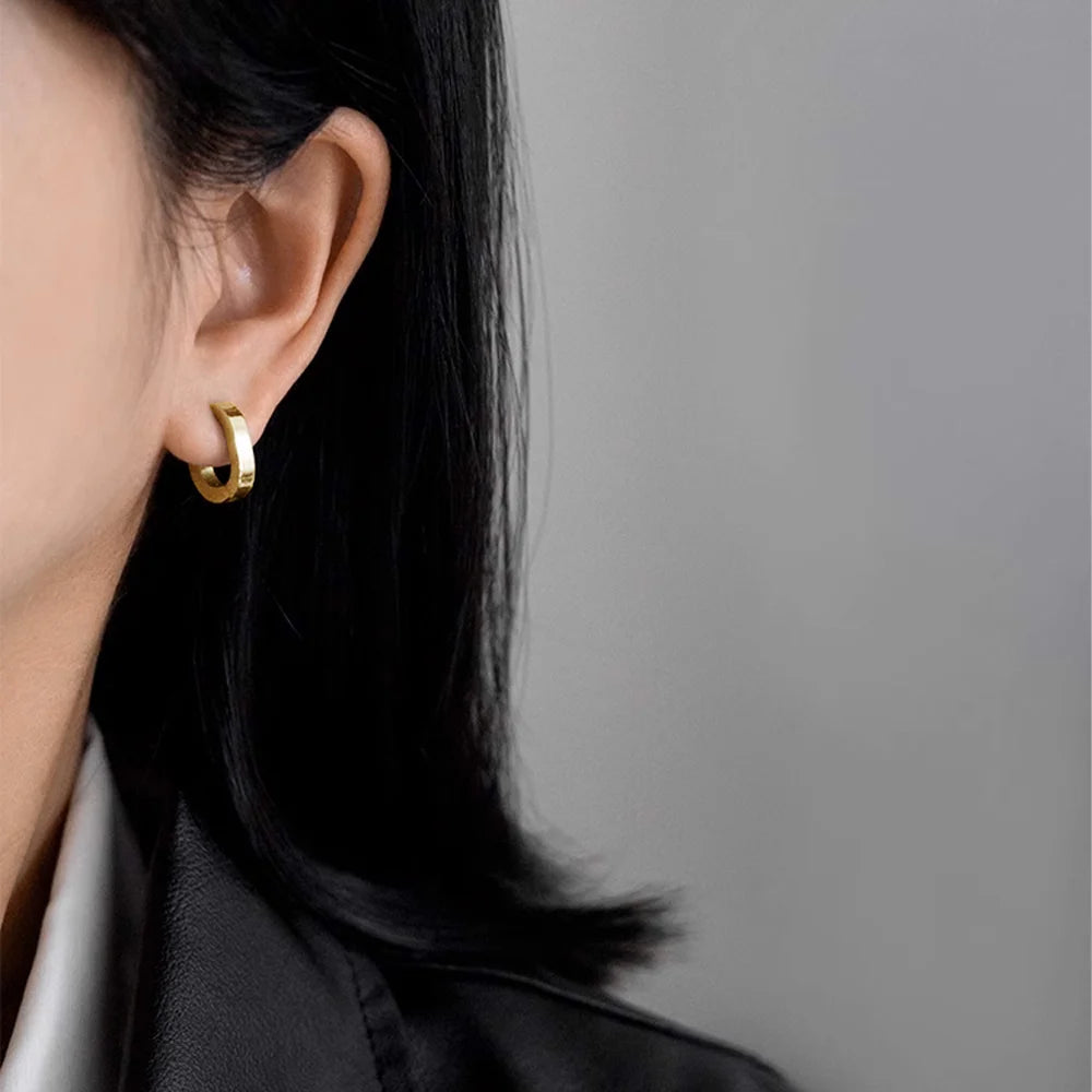 Model wearing Gold Horseshoe Clip-On Hoop Earrings.