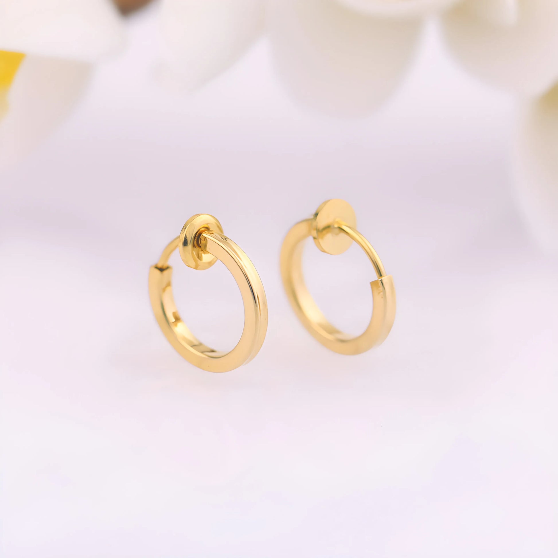 Close-up of Gold Mini Square Tube Clip-On Hoop Earrings showing sleek and polished 14k gold plated copper.