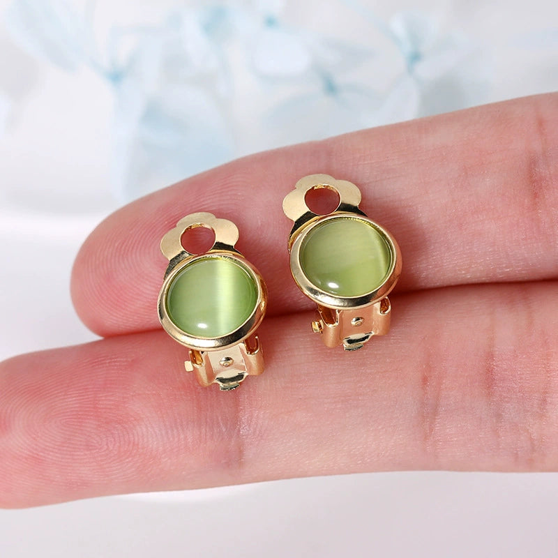 Women’s clip-on earrings with round green gemstone and gold trim