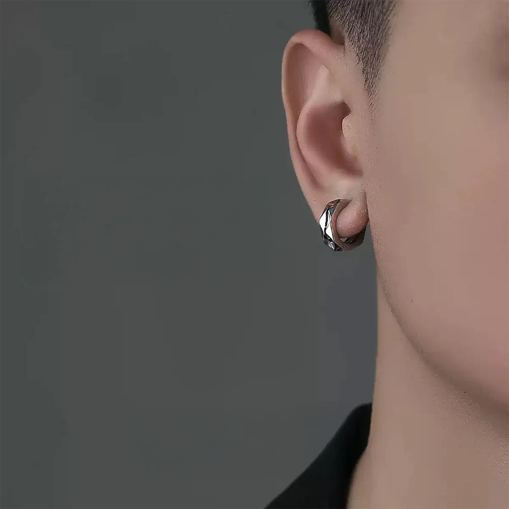 Male wearing shiny silver geometric clip earrings – bold look without piercing
