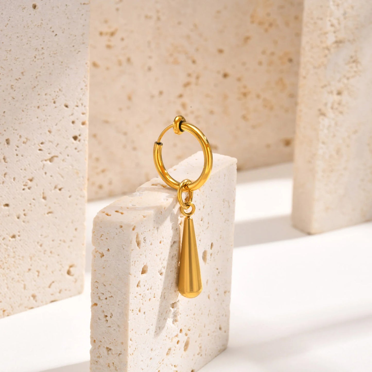 Close-up of Gold Clip-On Drop Earrings, combining luxury and practicality for men’s fake earrings.