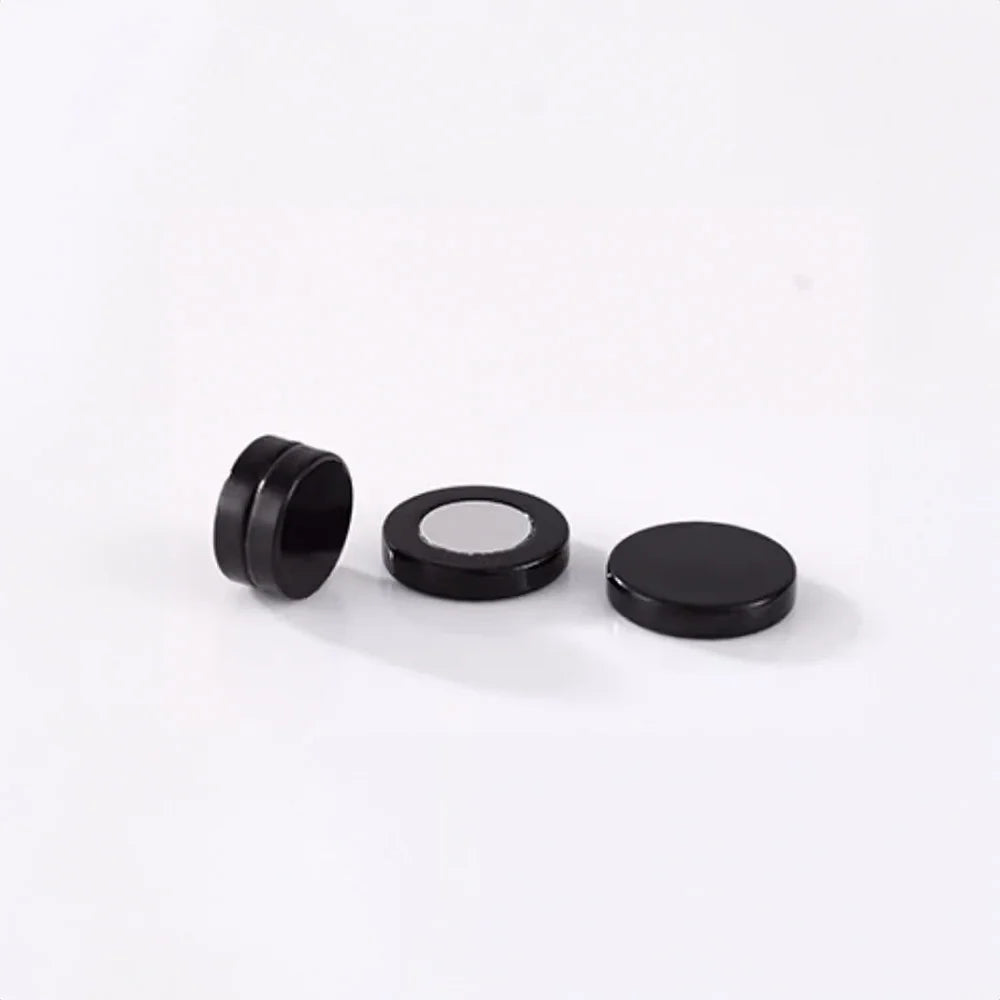 Hypoallergenic matte black magnetic ear studs for men, designed for sensitive ears and a secure fit.