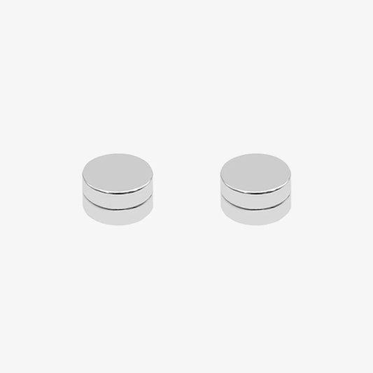 Close-up of stainless steel matte silver magnetic stud earrings, showing its smooth, non-piercing design.