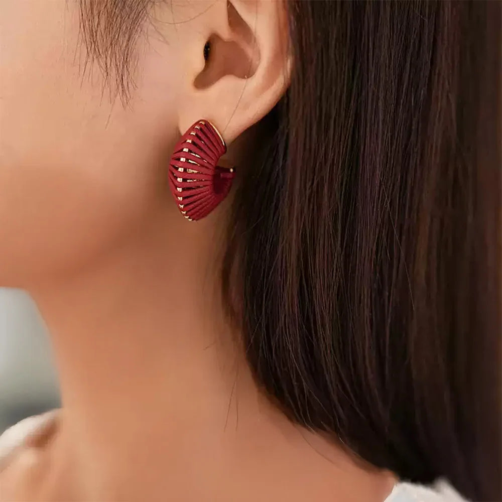 Red leather wrapped clip-on hoop earring worn on model