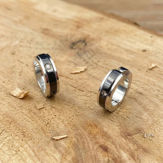 Close-up of fake diamond earrings for men with black stripe