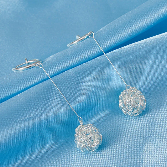 Close-up of Silver Filigree Ball Drop Clip-On Earrings on a white background.