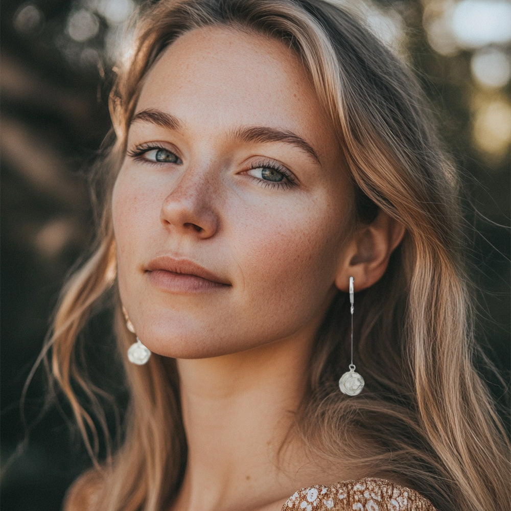 Model wearing the earrings, highlighting the elegant drop length.