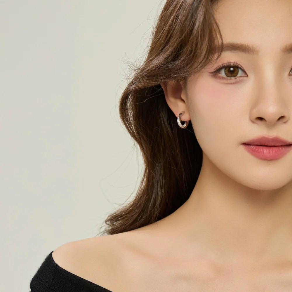 Model wearing white gold clip-on hoop earrings