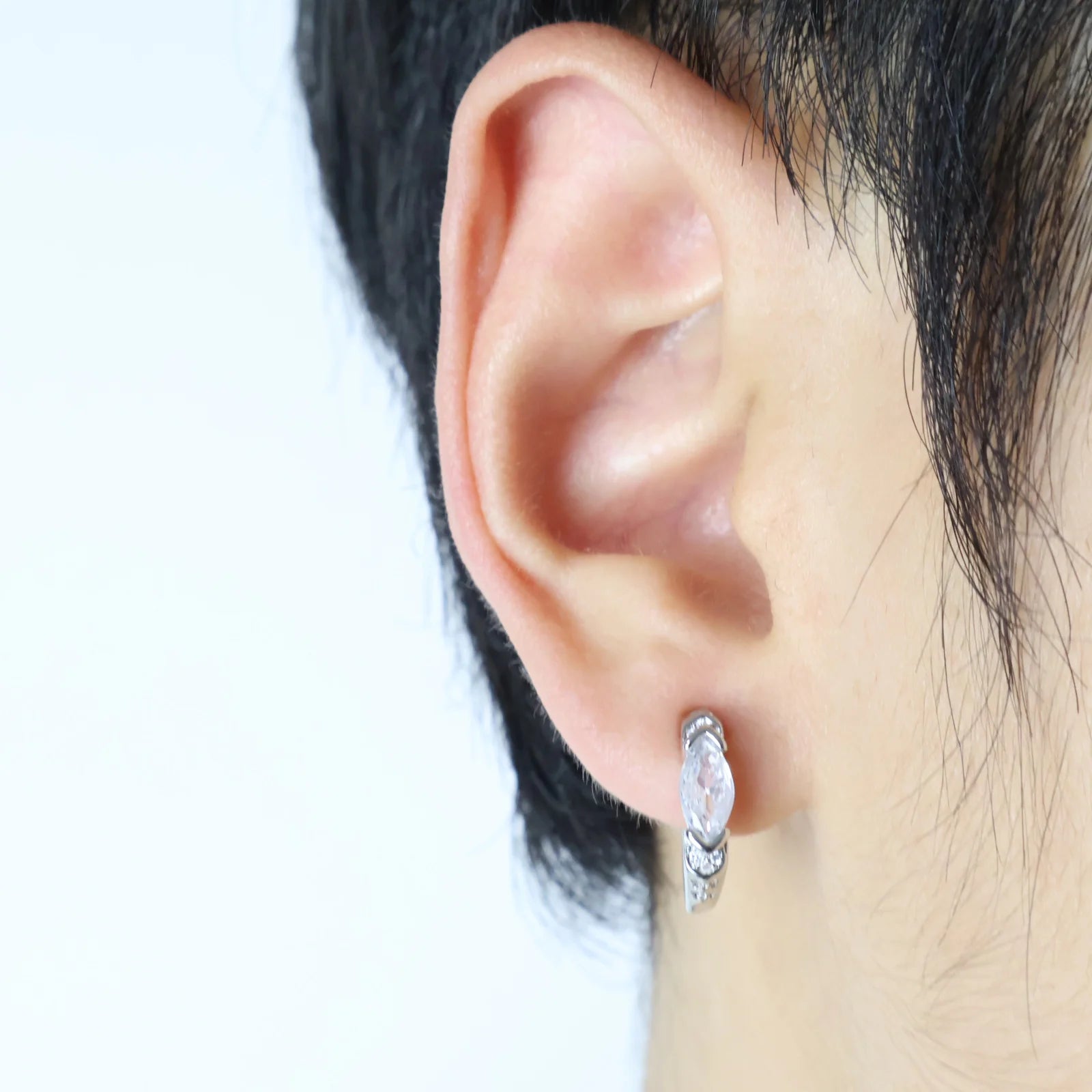 Model wearing White Zircon Silver Clip-On Hoop Earrings for men.