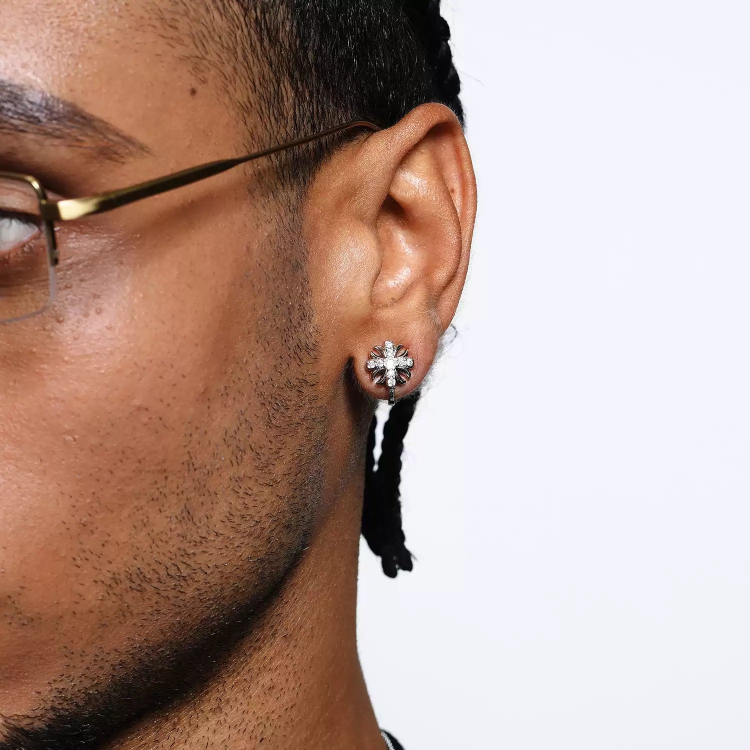 Male model wearing white gold plated cross ear studs