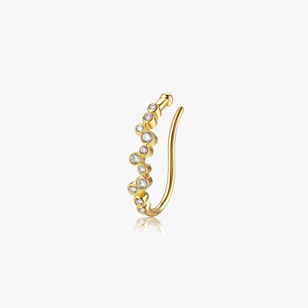 The Aura gold lobe cuff featuring a sparkling zircon cluster, shown on a clean white background to highlight its clip-on design.