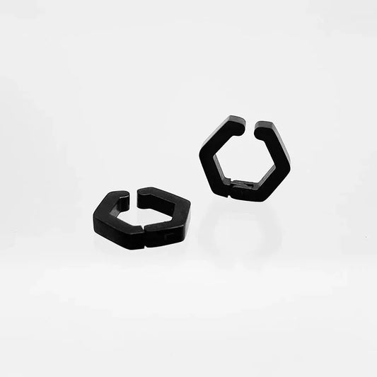 An angled view of the pair of black geometric earrings for non-pierced ears, highlighting their modern, hexagonal shape.