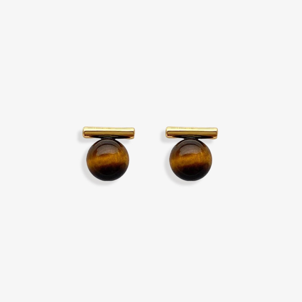 Vintage-modern tiger's eye clip-on stud earrings featuring brown resin beads with a coil clip-on closure, crafted from alloy. These stud earrings evoke the warmth of amber and the essence of the earth.