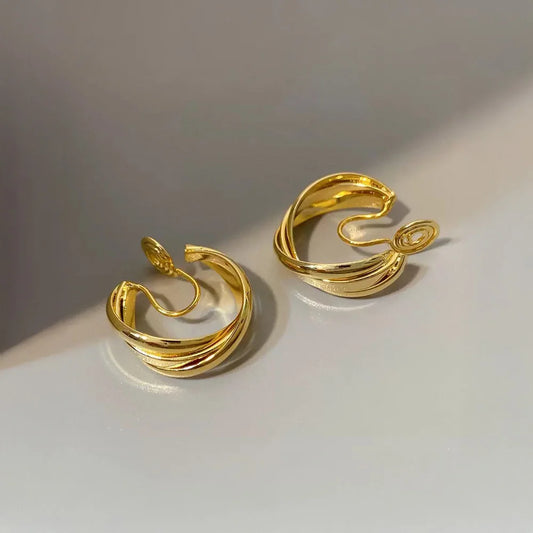 Side profile of the gold layered wave clip-on hoops, clearly showing the comfortable mosquito coil closure mechanism.