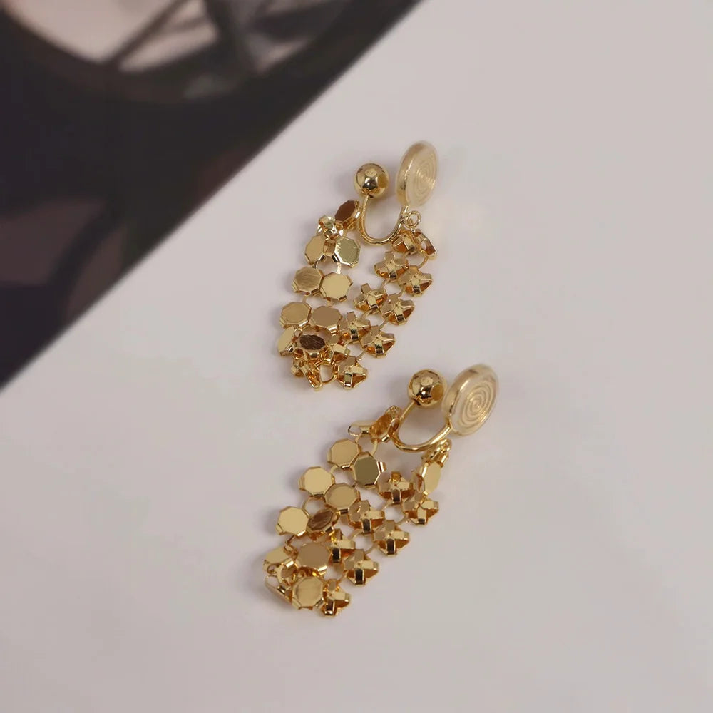 A detailed photo showing the gold honeycomb dangle earrings with an alternative adjustable u-type clip-on finding.