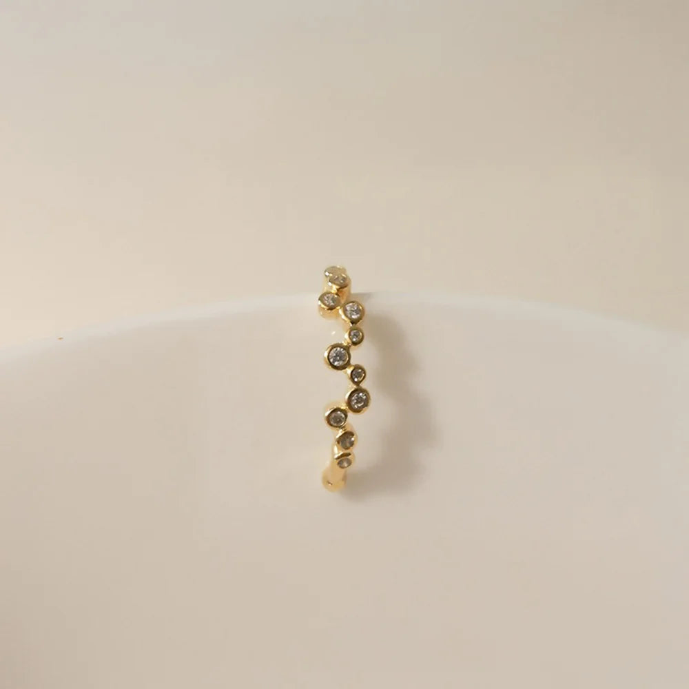 Detailed front view of the gold zircon cluster ear cuff, showcasing the arrangement of the sparkling stones.