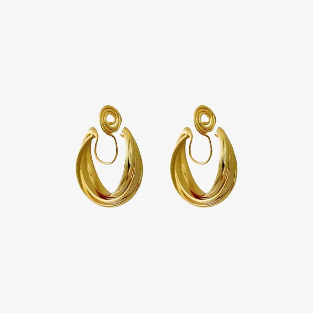 A pair of layered gold wave clip-on hoop earrings with a mosquito coil back, shown isolated on a clean white background.