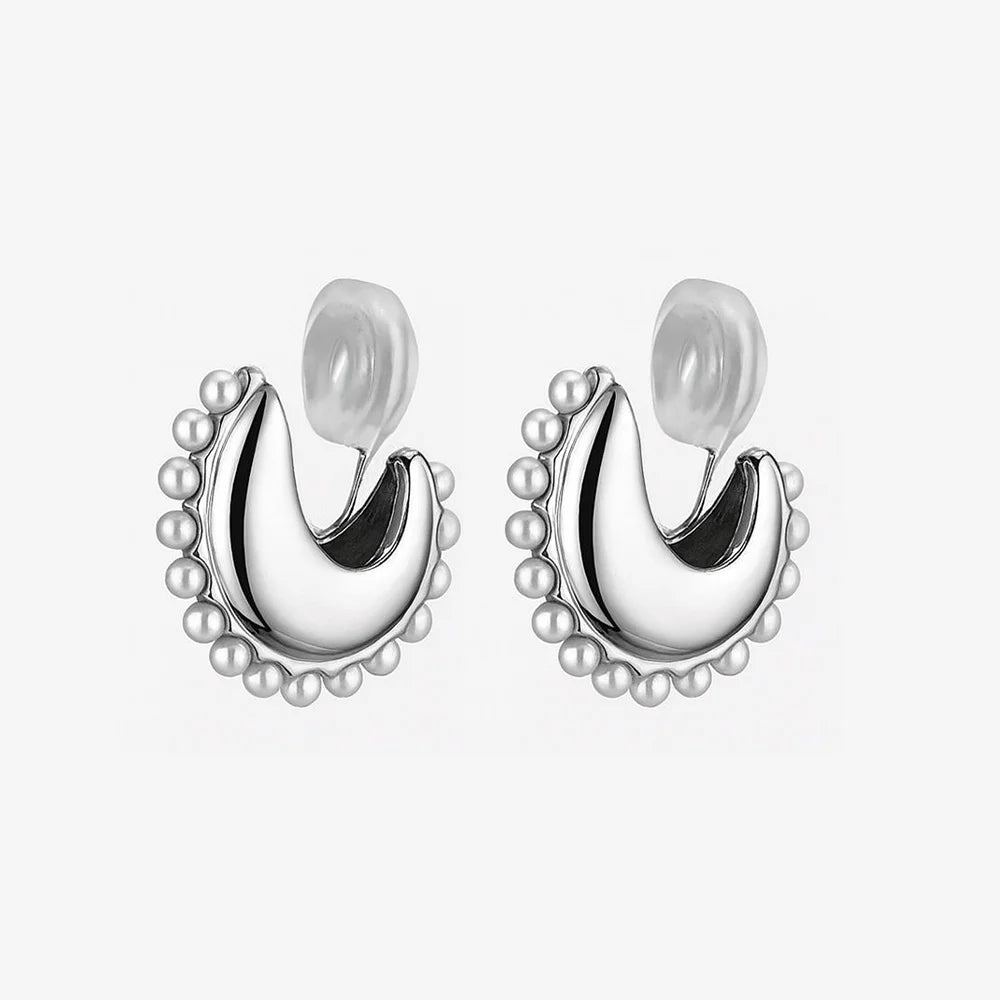 A pair of Luna pearl crescent clip-on earrings in polished silver with a faux pearl border and comfortable silicone pads, shown on a white background.