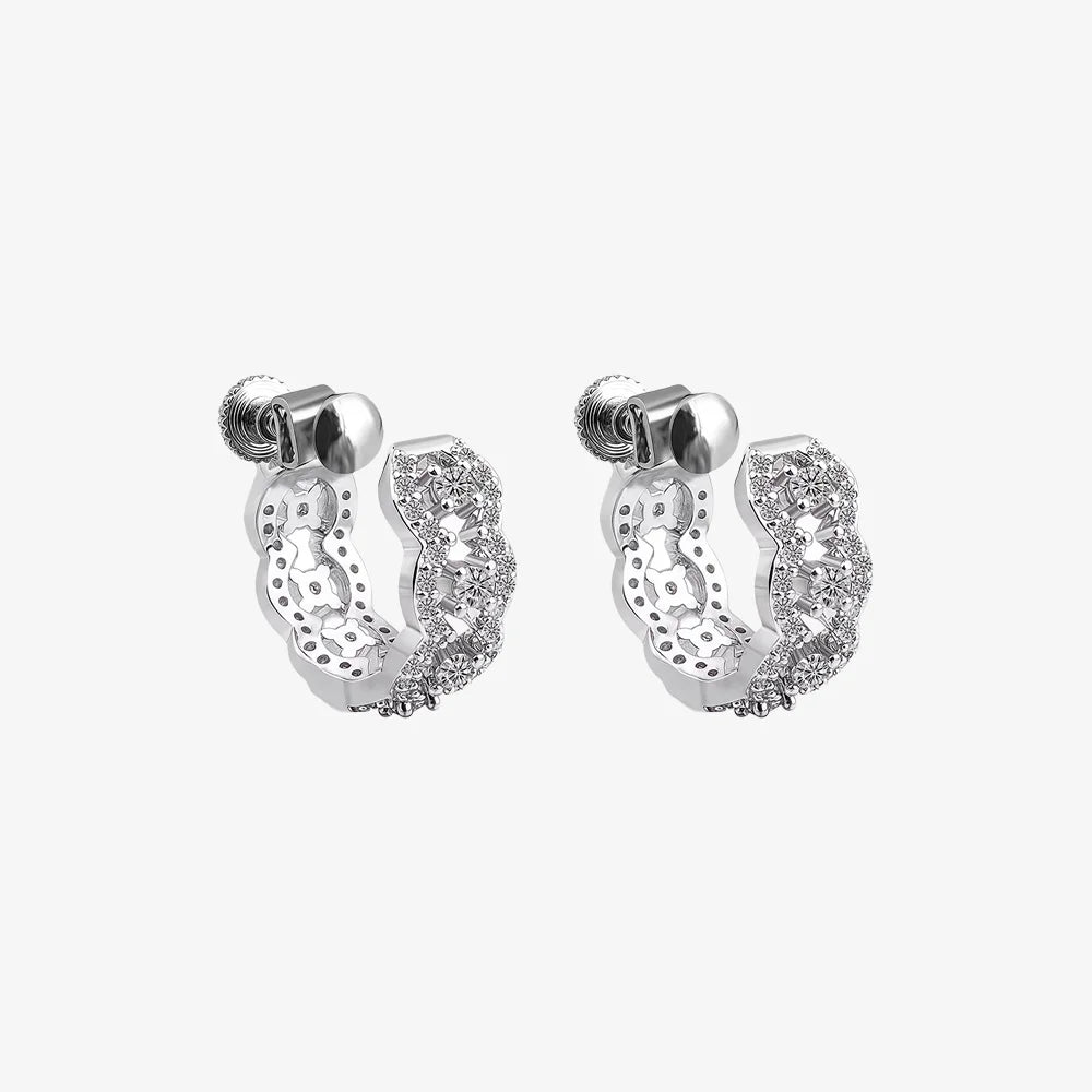 A pair of Luxe Iced Out Pavé Wave Clip-On Hoop Earrings in silver, displaying the detailed moissanite setting and secure screw-back closures.