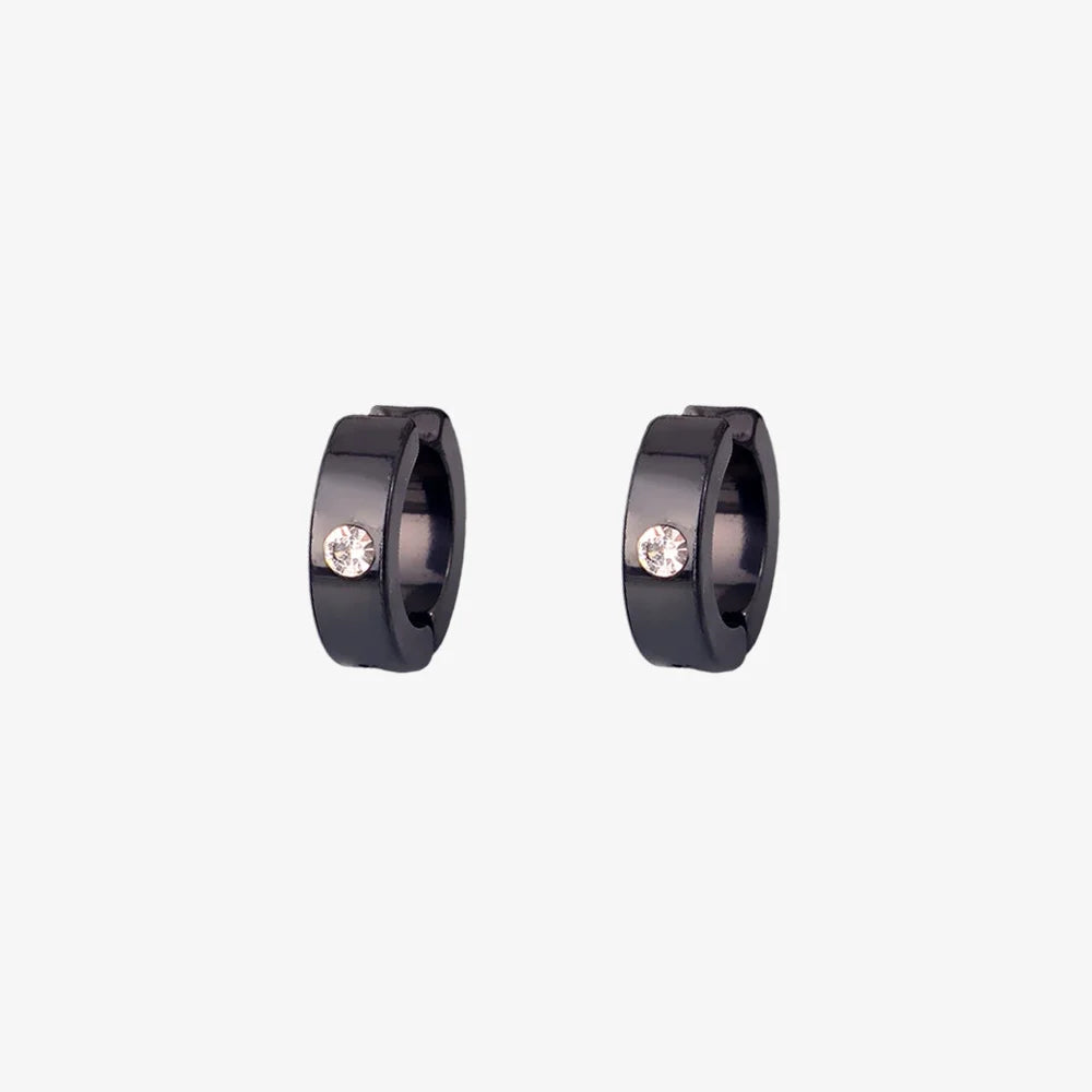 A pair of minimalist men's clip-on hoop earrings in black with a single inset cubic zirconia stone, shown isolated on a white background.