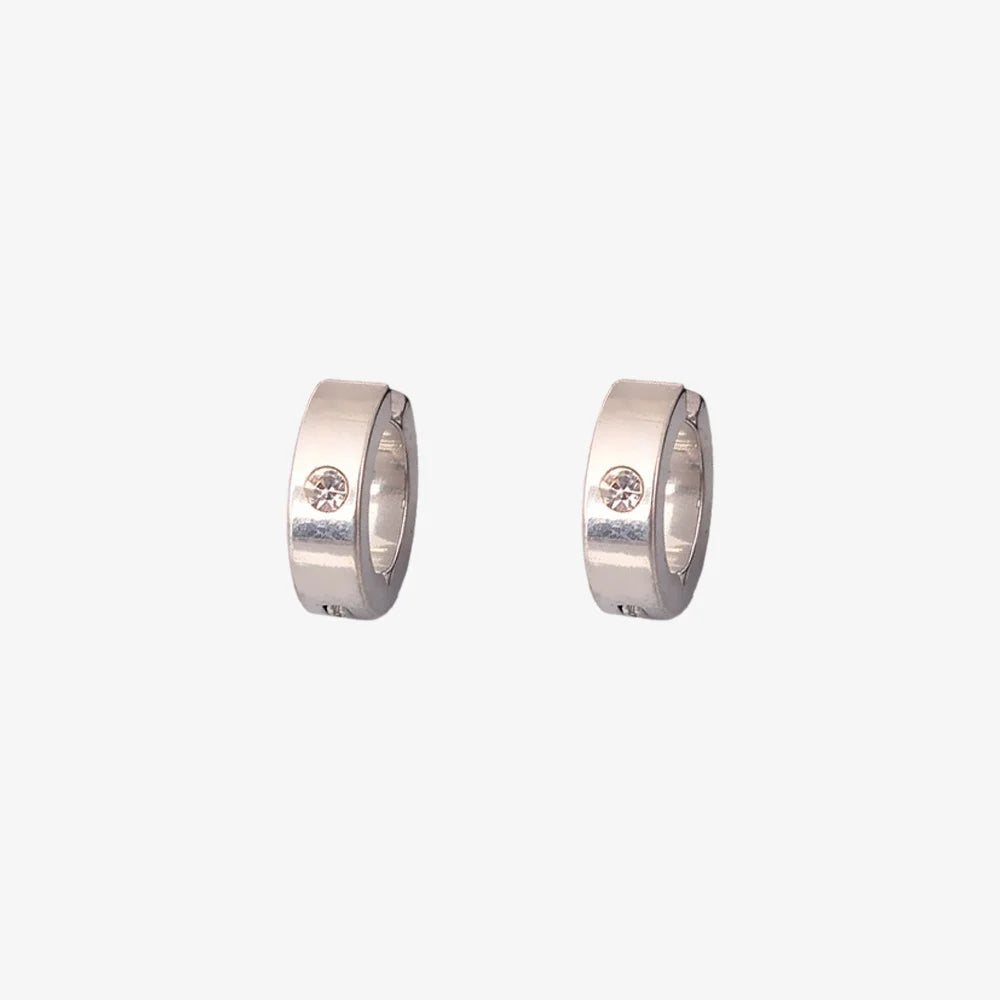 A pair of minimalist men's clip-on hoop earrings in silver with a single inset cubic zirconia stone, shown isolated on a white background.