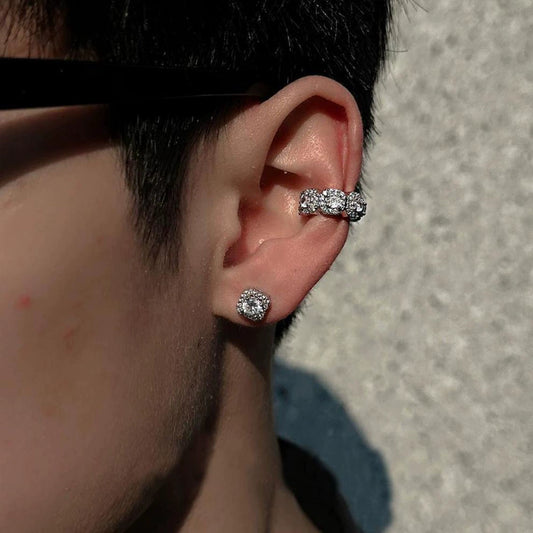 A model wearing the Halo Nova silver triple zircon pavé clip-on ear cuff on the upper cartilage, paired with a matching stud, creating a stylish ear stack.