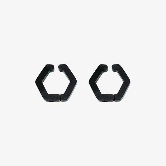 A pair of matte black hexagon geometric clip-on earrings, made from titanium steel, shown on a clean white background.