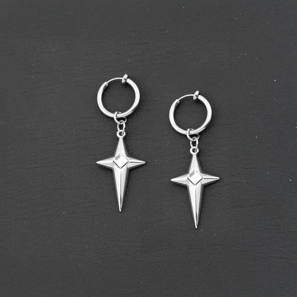 A pair of silver clip-on hoop earrings with dangling four-pointed star charms, each set with a white gem in the center, on a black background.