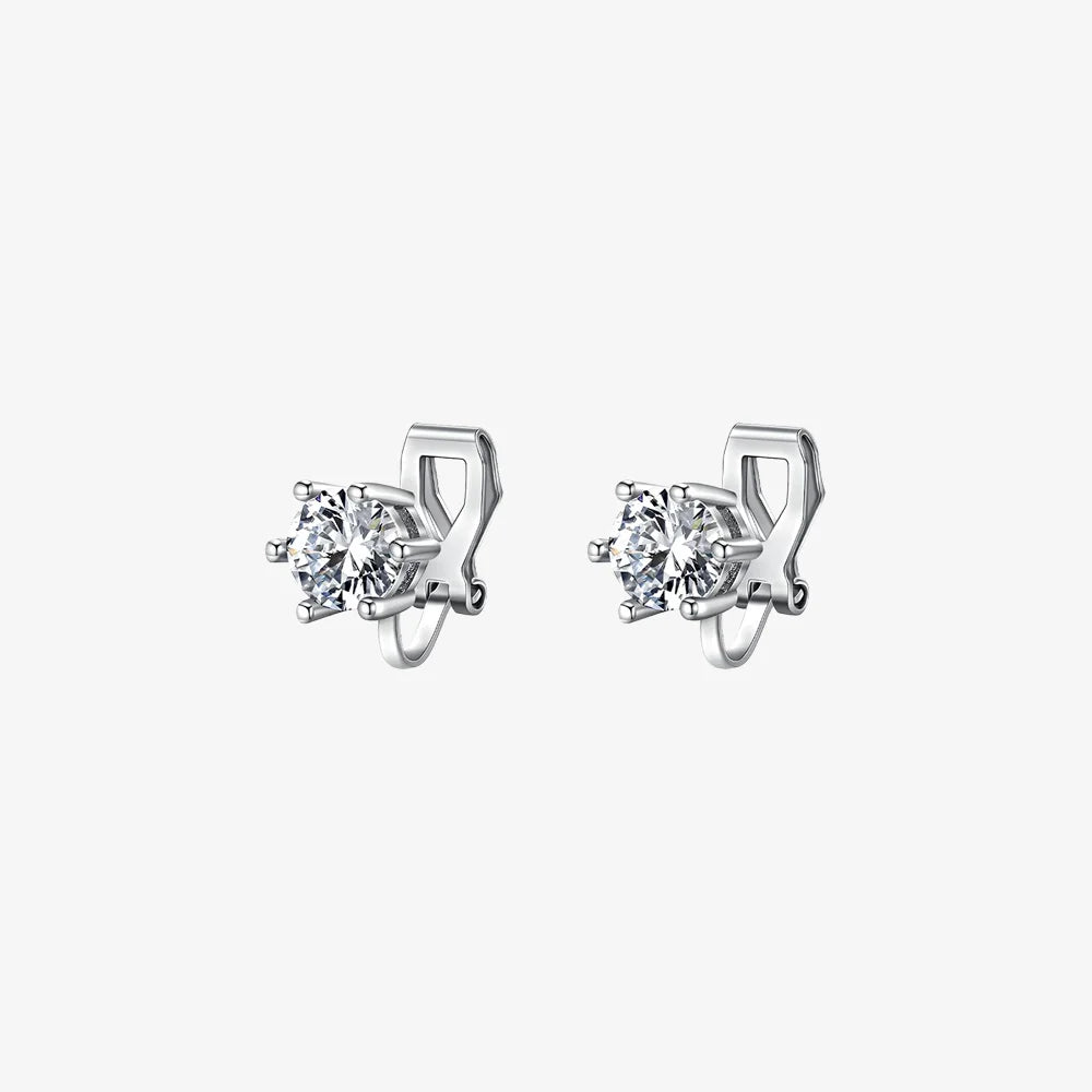 A pair of silver solitaire clip-on stud earrings featuring round-cut cubic zirconia in a six-prong setting, shown on a white background.