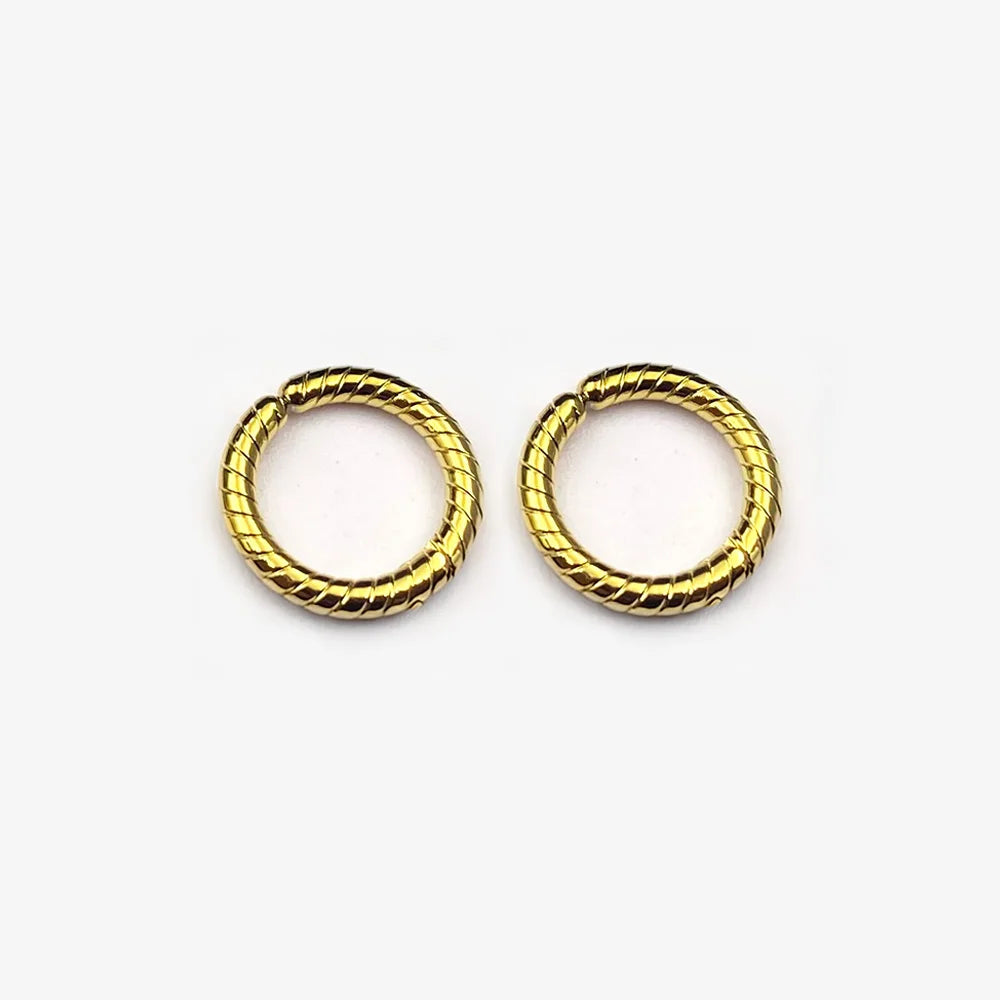 A pair of twisted rope textured clip-on hoop earrings in a polished gold finish, shown isolated on a white background.
