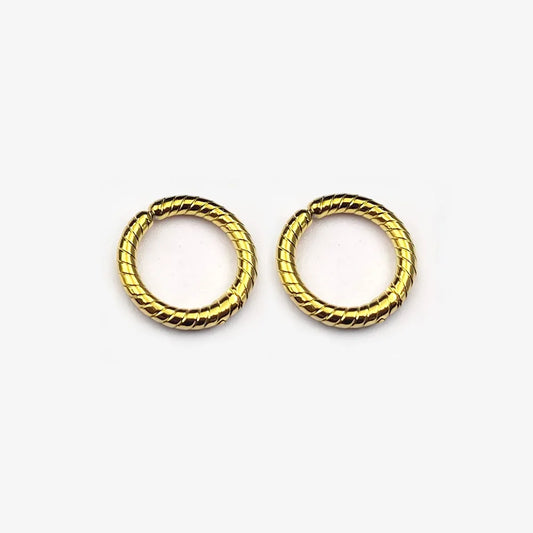 A pair of twisted rope textured clip-on hoop earrings in a polished gold finish, shown isolated on a white background.
