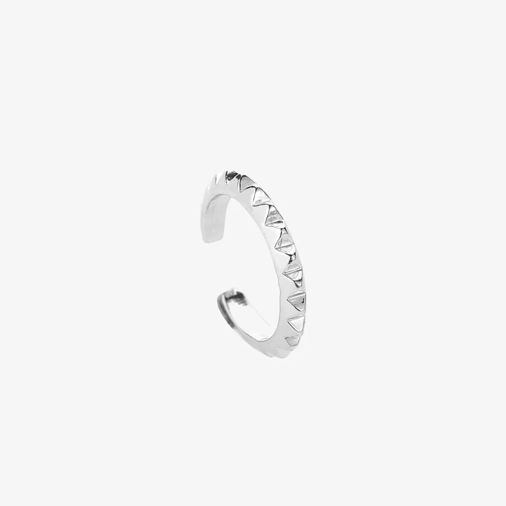 A single Rocker Stud ear cuff in 925 sterling silver, shown isolated on a clean white background to highlight its pyramid stud details.