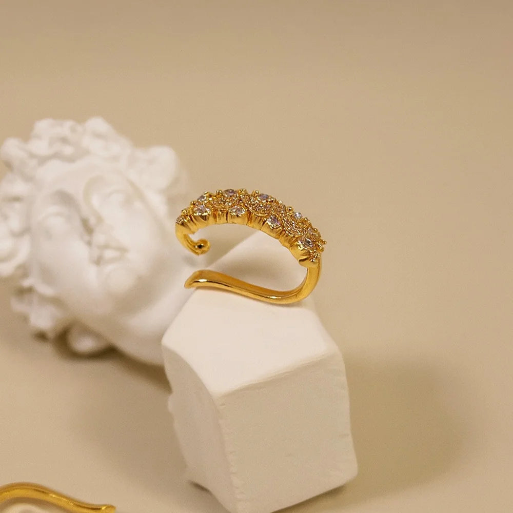 Side view of the pave zigzag gold ear cuff, showing how it curves to wrap around the ear.