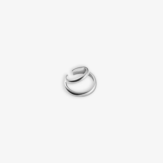 A single silver Dual Loop Ear Cuff showcased on a plain white background. The conch cuff's silver finish reflects a contemporary edge, ideal for special events when paired with formal attire, providing an elegant but modern accessory choice.