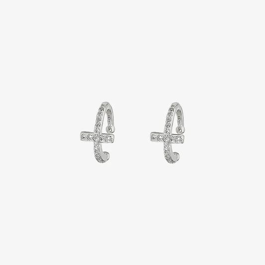 A single silver pavé cross clip-on ear cuff, adorned with sparkling cubic zirconia, shown isolated on a white background.