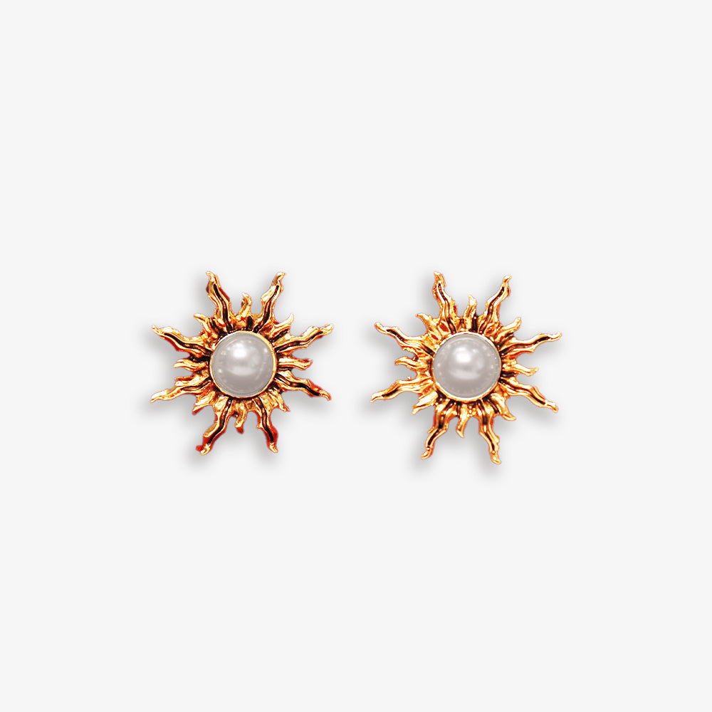 Reach for the sun with these elegant gold sunburst clip-on earrings.  Featuring delicate faux pearls, they add a touch of celestial flair to any outfit.  The hinged back clip-on closure ensures a secure and comfortable fit for non-pierced ears.
