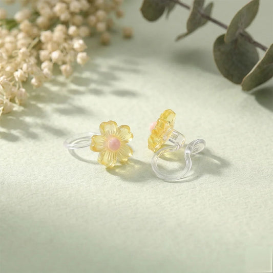 Pair of honey yellow daisy candy color earrings with a translucent jelly finish and pink centers.