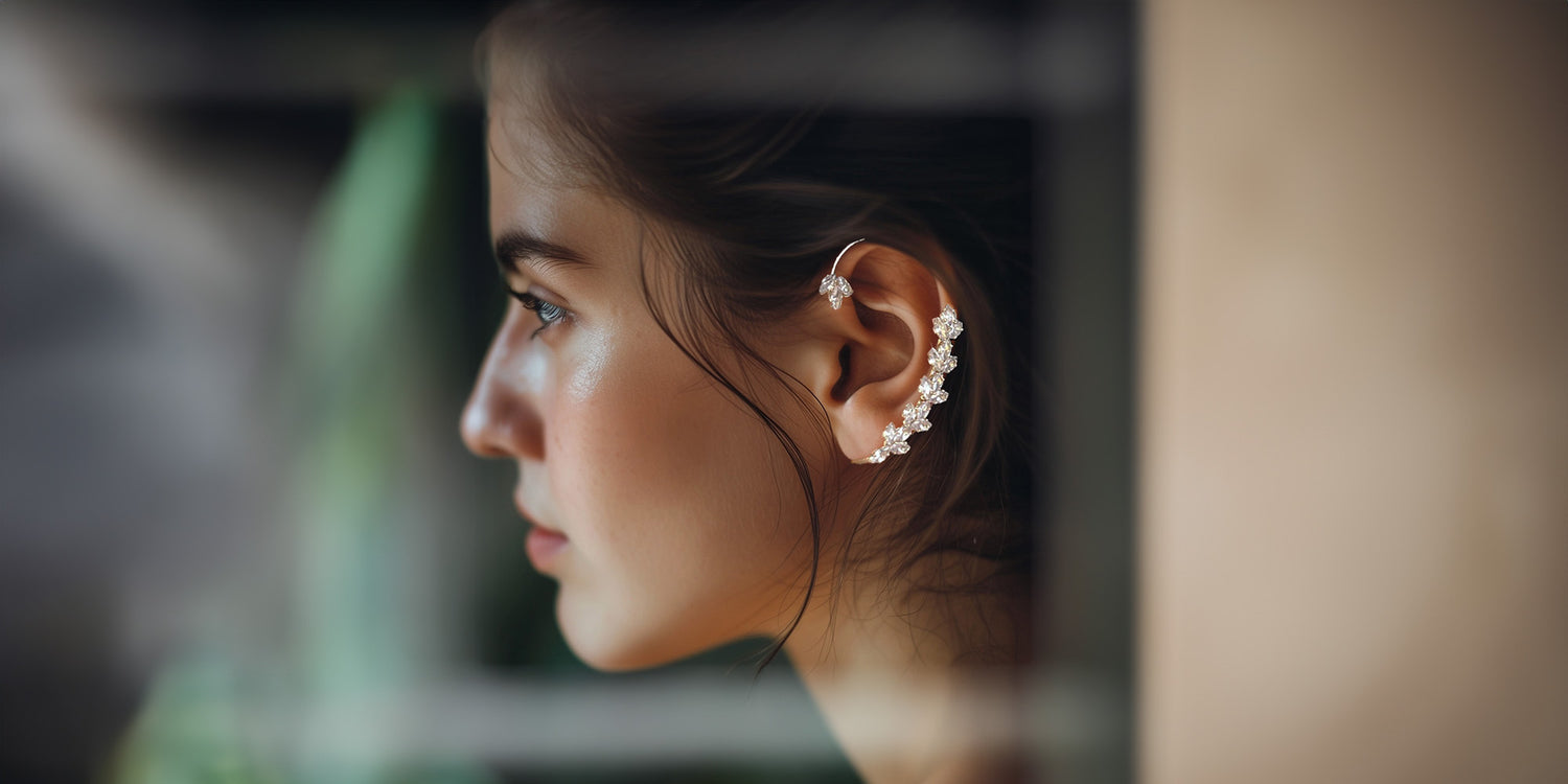 Silver tone ear wrap cuff earring adorned with a delicate bow design and cascading faux pearls.