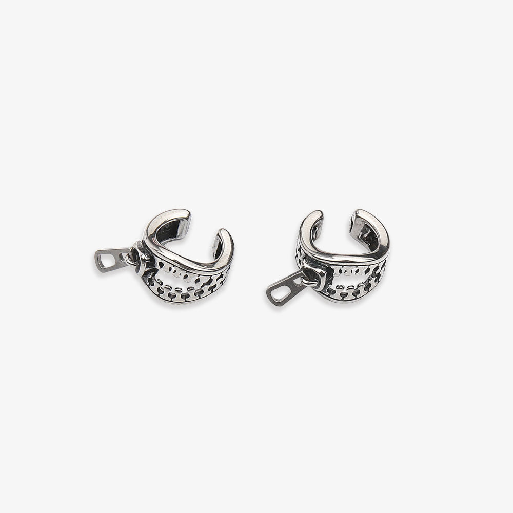 Two silver Zipper Conch Ear Cuffs showcased against a white backdrop, one standing upright and the other laying flat, highlighting the zipper and pull-tab details. These gender-neutral ear cuffs are versatile for daily use, seamlessly blending with professional or casual looks.