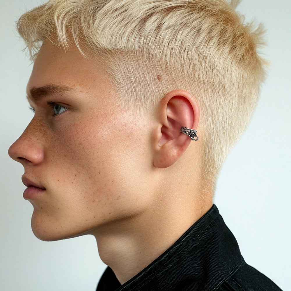 A profile view of a young man wearing a silver Zipper Ear Cuff on their left ear, set against a neutral background. The ear cuff adds a subtle yet bold statement, suitable for special events or when aiming to make a standout fashion statement.  Conch ear cuffs for men.