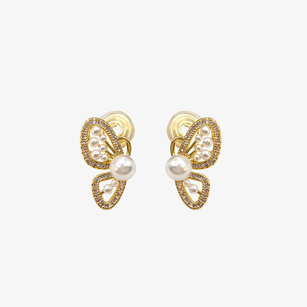 Glamorous Butterfly Wing Clip-On Pearl Earrings, adorned with faux pearls and zircon on a golden alloy base. These non piercing ear studs flaunt a delicate coil clip-on closure, suitable for both daily wear and special events, adding a touch of whimsy and elegance.