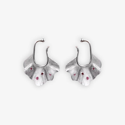 Pair of silver Ginkgo Leaf Ear Conch Cuff Earrings with cherry red zircon accents displayed on a white background, symbolizing nature's eternal elegance and perfect for adding a botanical touch to any outfit.