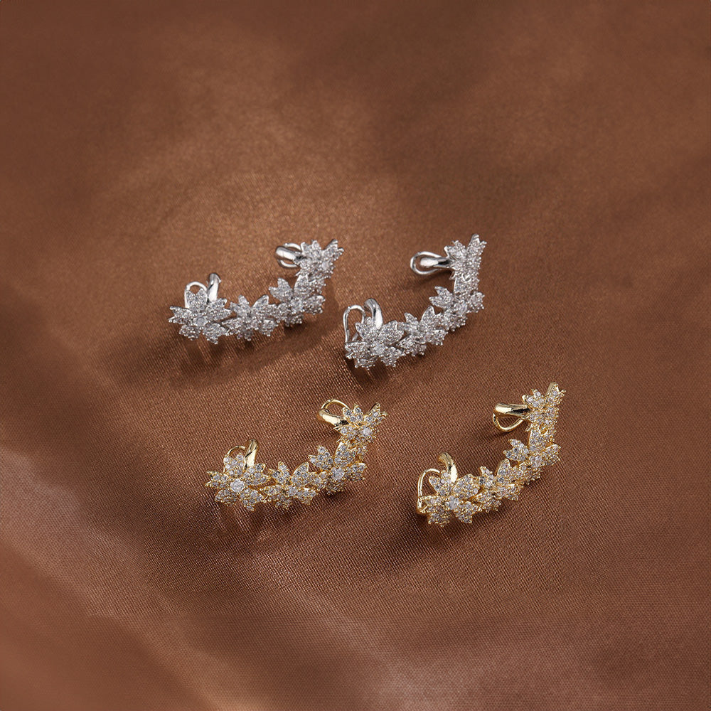 Assortment of Blossom Flower Crystal Helix Ear Cuffs, featuring designs in both warm gold and timeless white gold, each piece studded with bright zircon gems to capture the light.