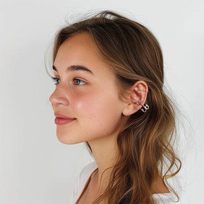 Side profile of a young woman wearing the Dual Paperclips Conch Ear Cuffs. The white gold finish and sparkling zircon embellishments add a touch of effortless sophistication to her casual look.